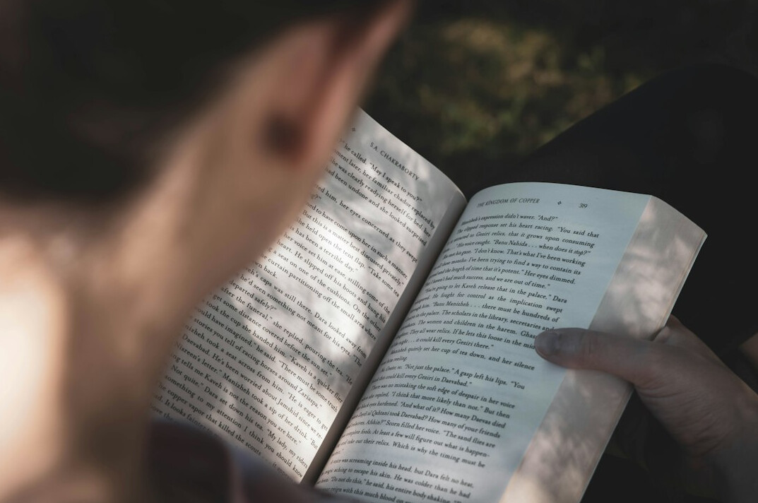 young woman reading book